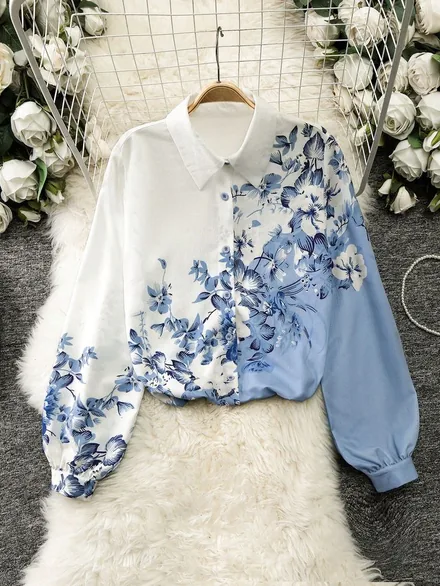 Blue botanical print blouse laid on a cream fur throw with white roses